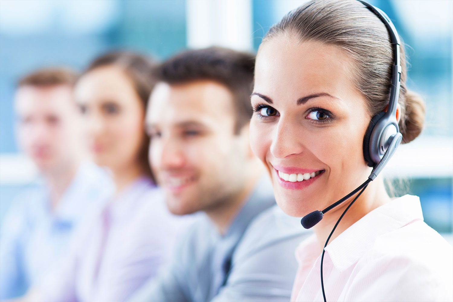 help desk employees with headsets talking to customers
